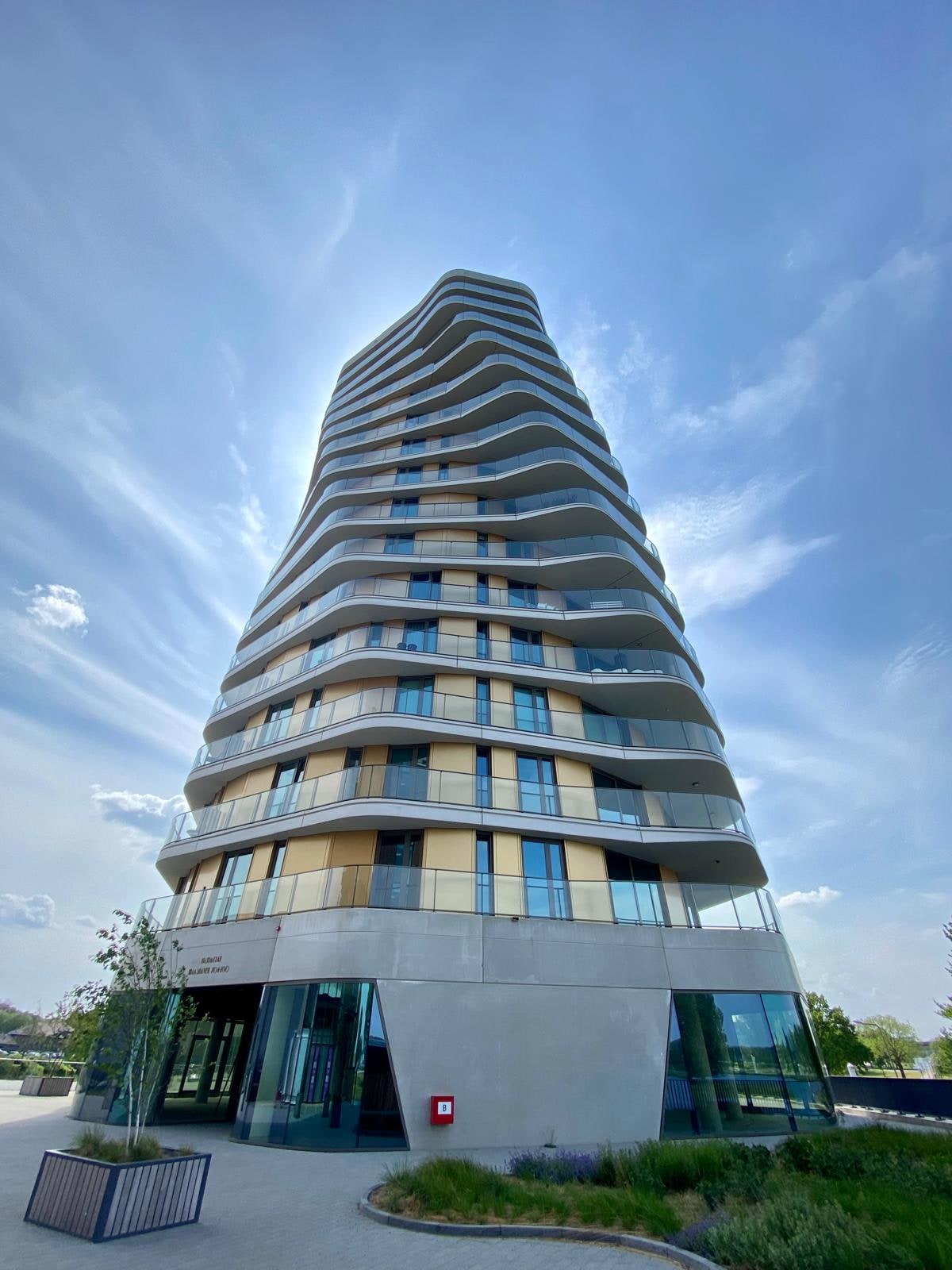 Appartementengebouw met golvende balkonranden rondom: een complex waarvan de gevel, de balkons en het dak gemeenschappelijke bouwdelen van de VvE zijn
